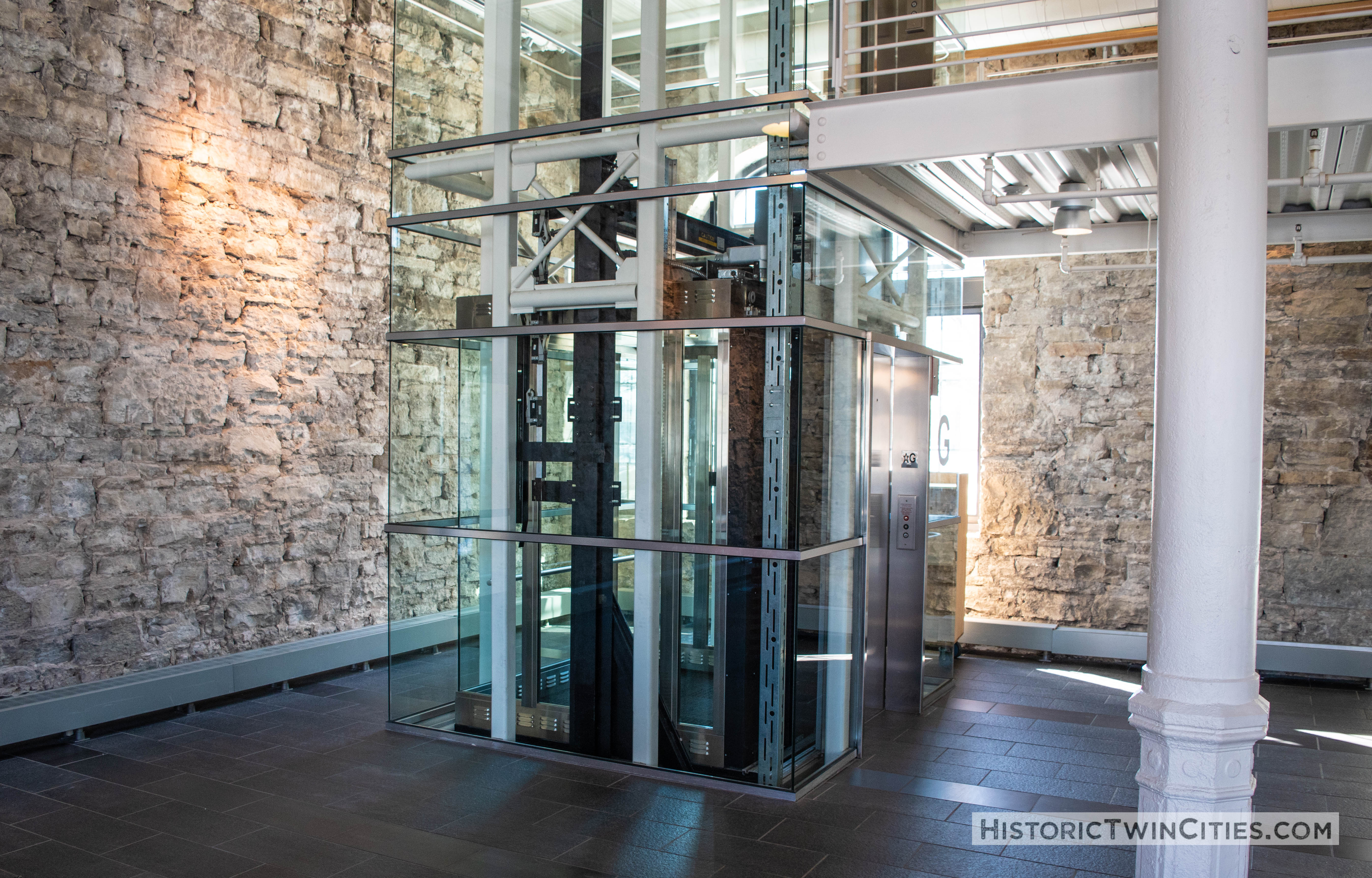 Glass elevator added during the renovation located where on of the original copper brew tanks sat