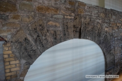 Original keystones surrounding an arch on the ground level featuring the original quarry markings