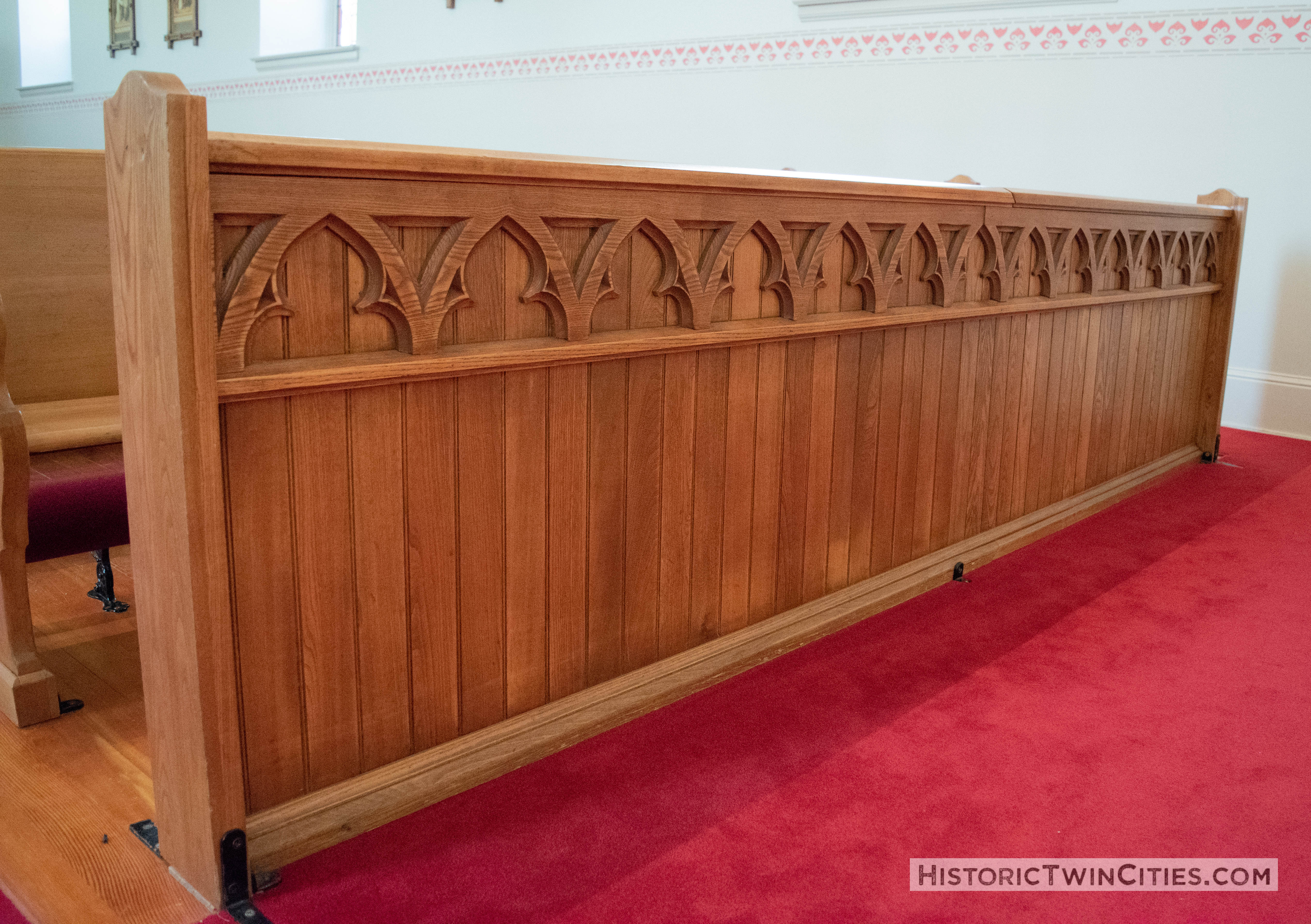 Ornate woodwork on the front row pew in the Historic Church of St. Peter in Mendota