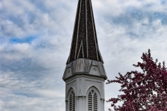 Belfry and spire atop the steeple of the Historic Church of St. Peter in Mendota