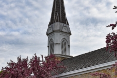 Belfry and spire atop the steeple of the Historic Church of St. Peter in Mendota