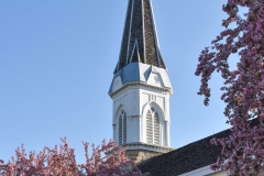 Belfry and spire atop the steeple of the Historic Church of St. Peter in Mendota