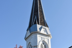 Belfry and spire atop the steeple of the Historic Church of St. Peter in Mendota